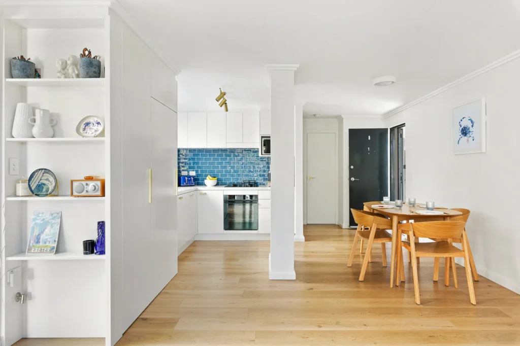 Cane armchairs beside a window with water views in a Randwick holiday rental
